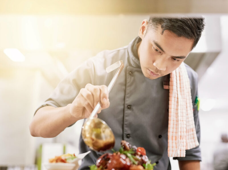 Cropped shot of a young male chef cooking in a restaurant kitchen