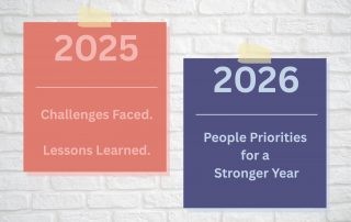 2025 and 2026 Calanders stuck to brick wall. 2025 HR Review and Priorities for 2026